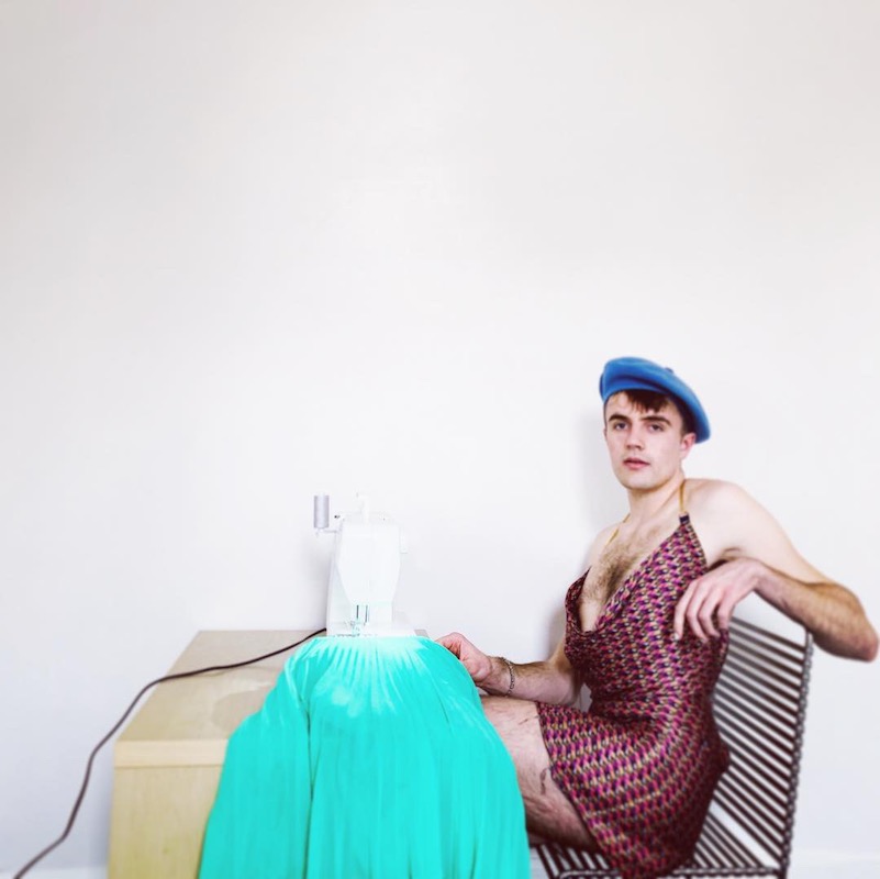 Man looking confrontational at a sewing machine